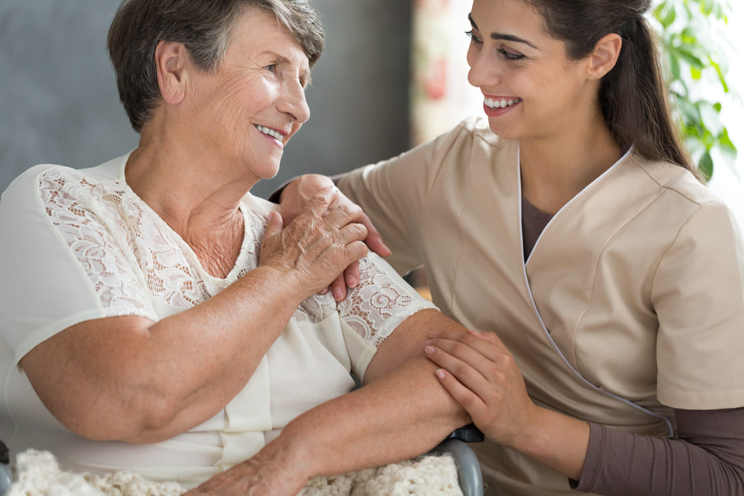 Royal Homecare Solutions companion assisting an older woman